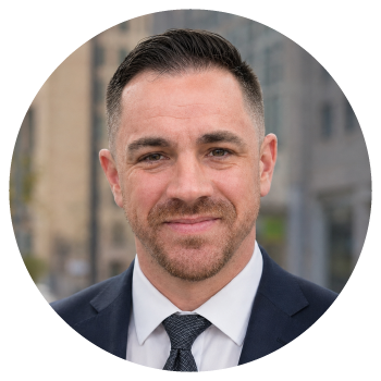 Professional headshot of a smiling man in a suit