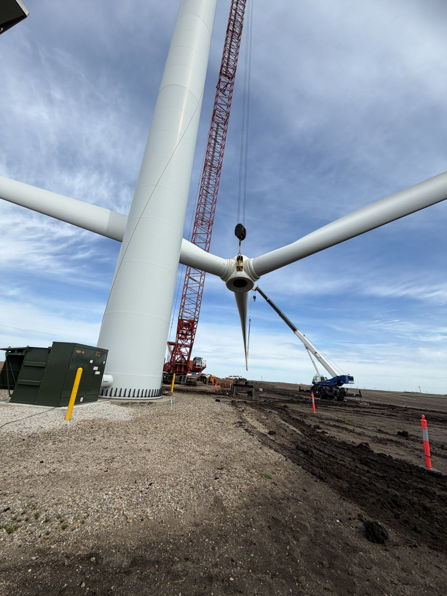 Wind turbine rotor installation with cranes at construction site
